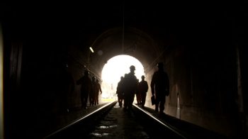 540458614-light-at-the-end-of-the-tunnel-work-clothing-safety-suit-train-tunnel